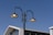 A close-up of a modern LED lamp installed on a street pole during the day.