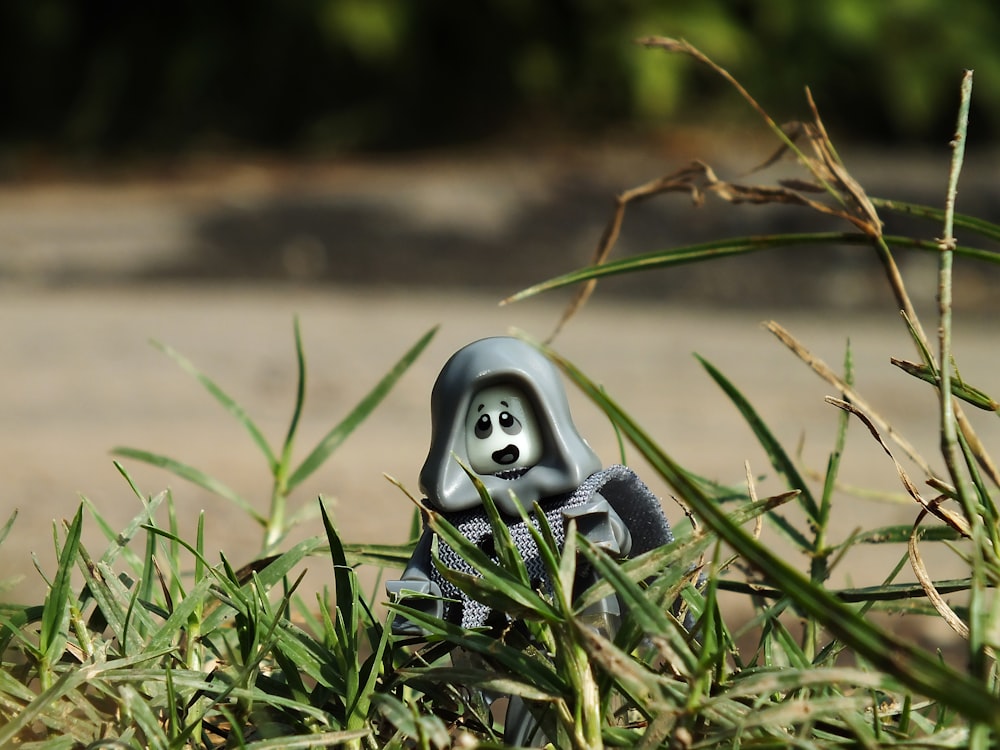 a small toy sitting in the middle of some grass