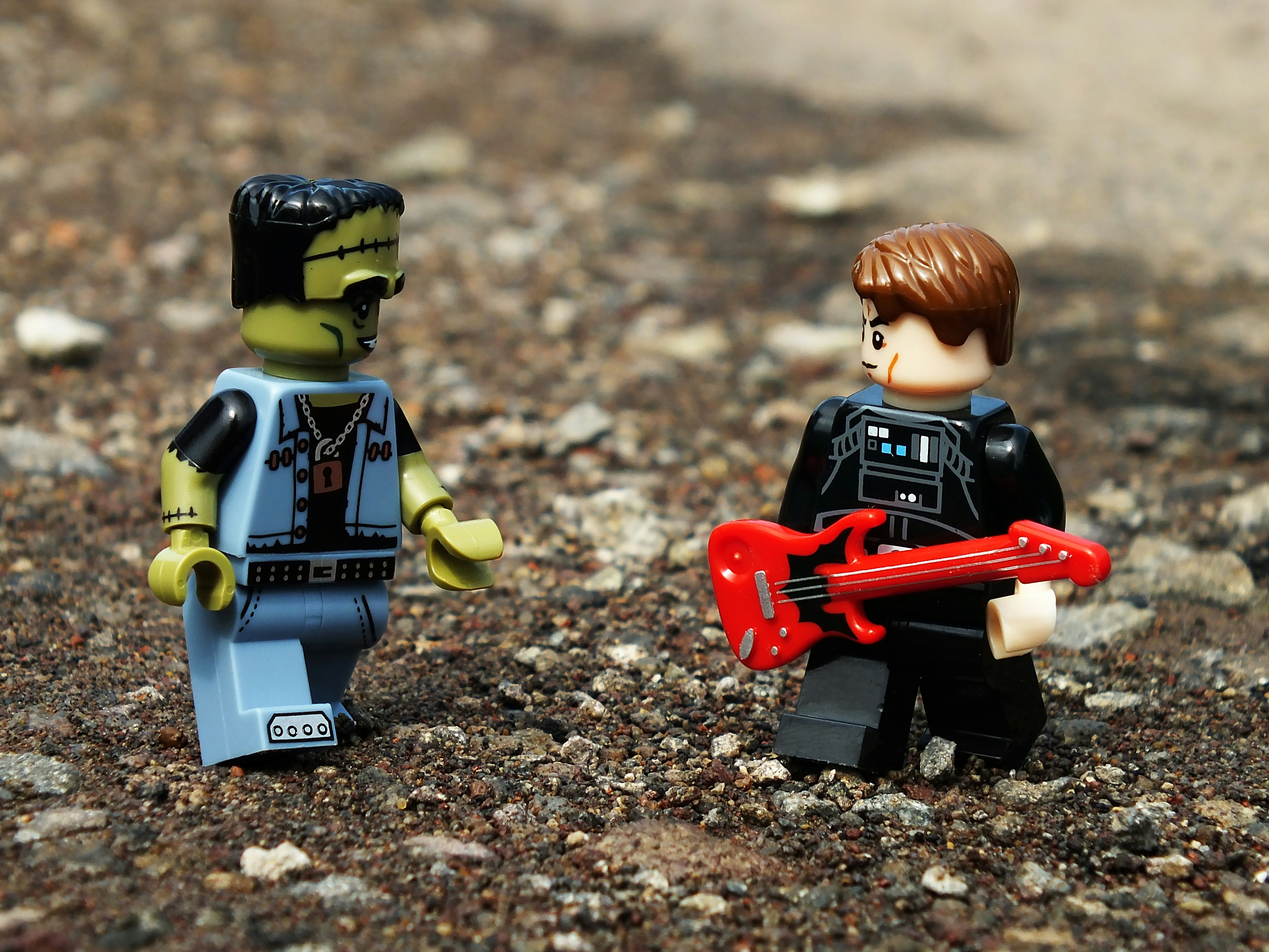 a couple of legos that are standing in the dirt