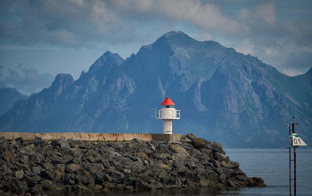 a light house sitting on top of a rocky pier