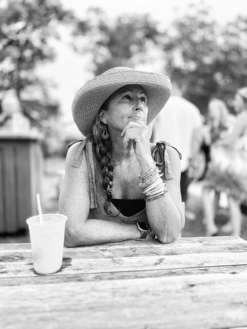 a woman wearing a hat sitting at a table