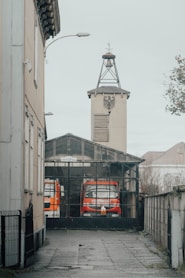 a red and white truck parked in front of a building