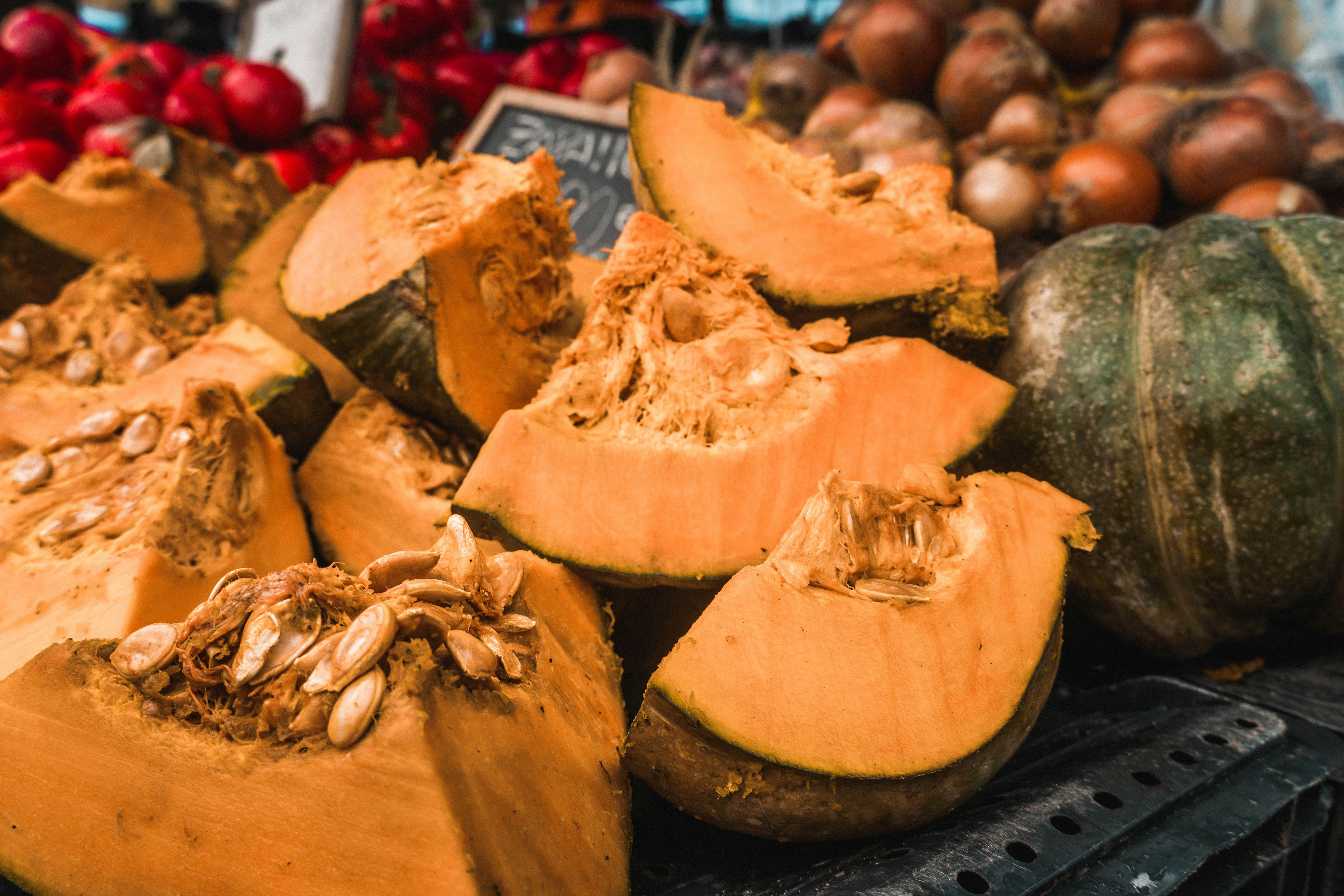 A pile of pumpkins sitting on top of a table photo – Free Red Image on ...