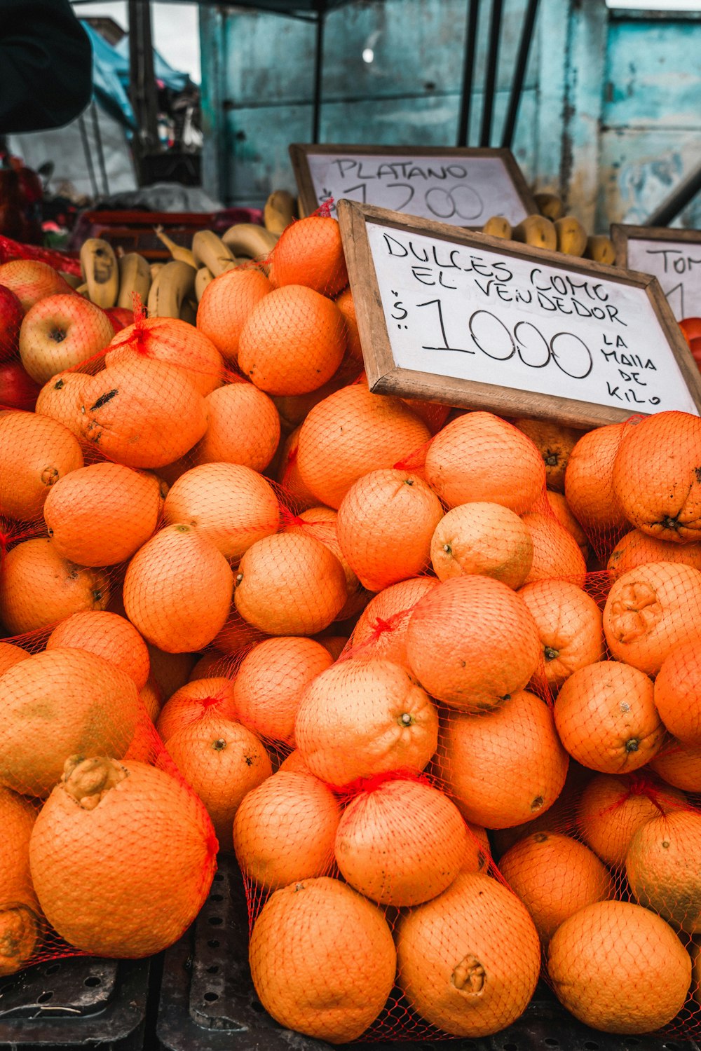 a pile of oranges for sale at a market