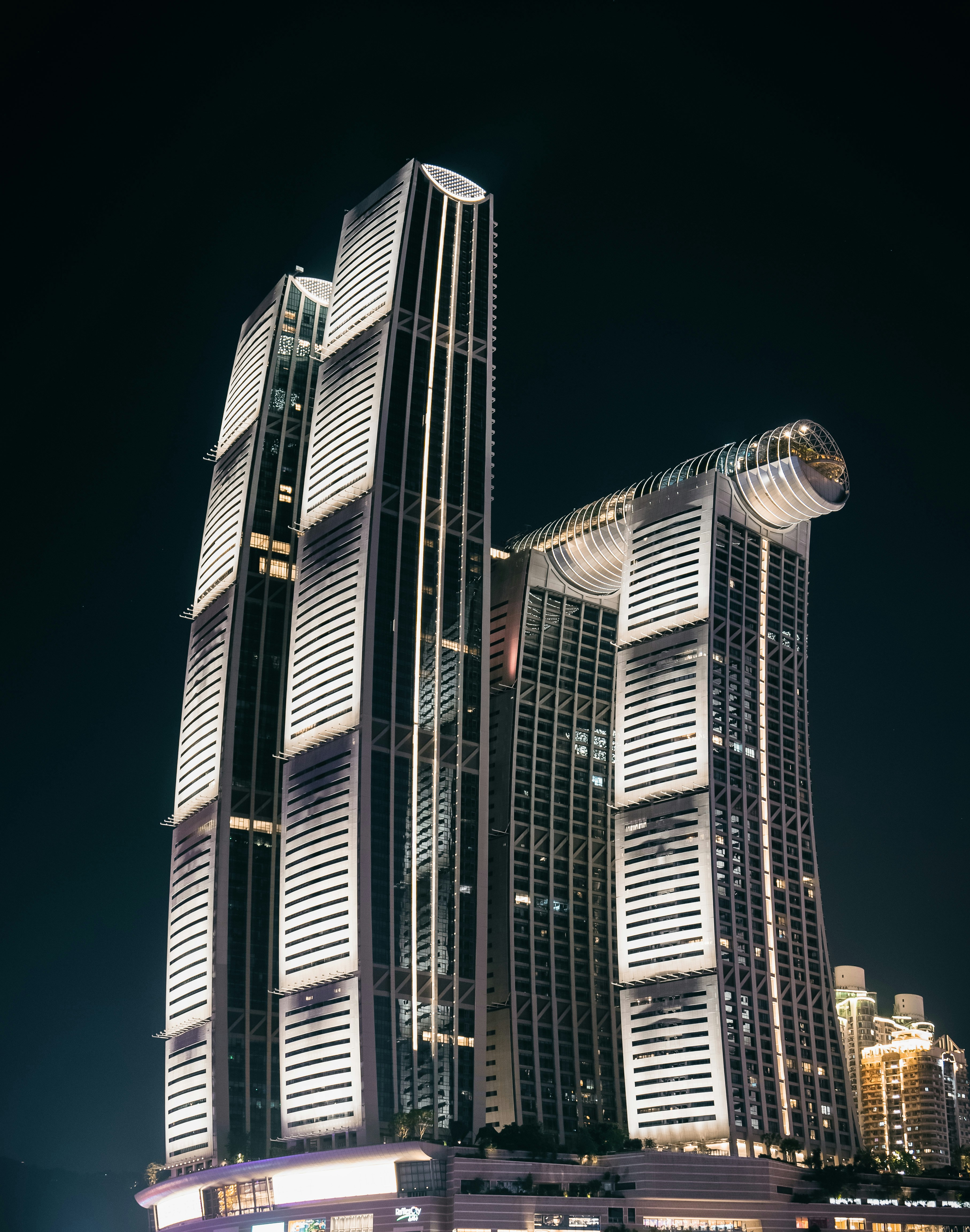 a very tall building in the middle of a city at night