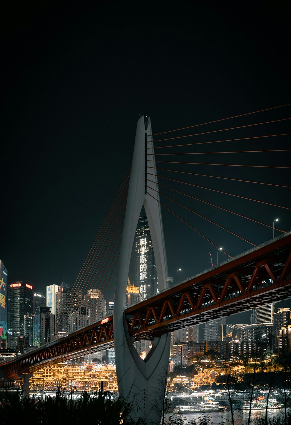 a very tall bridge with a very tall building in the background