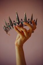 A delicate pink and gold princess-themed invitation with sparkling crowns.