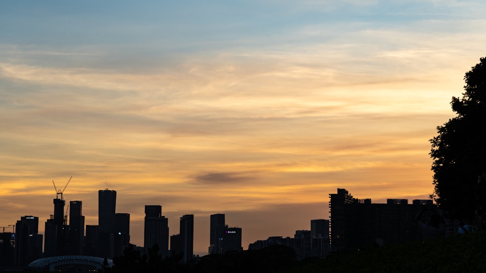 a view of a city skyline at sunset