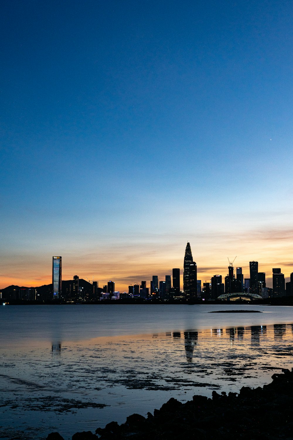 a large body of water with a city in the background