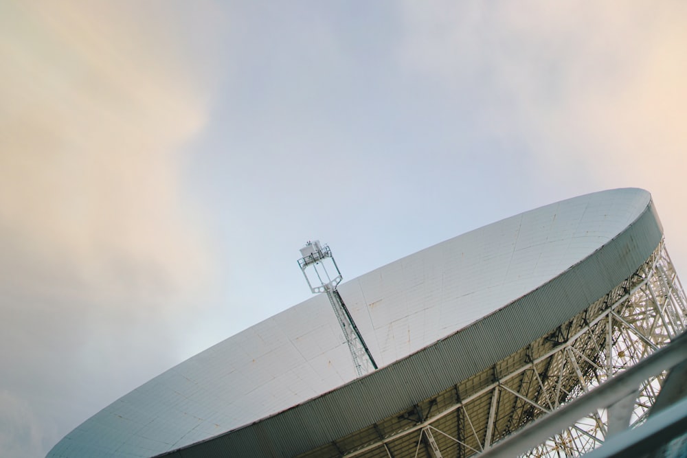 a large satellite dish sitting on top of a metal structure