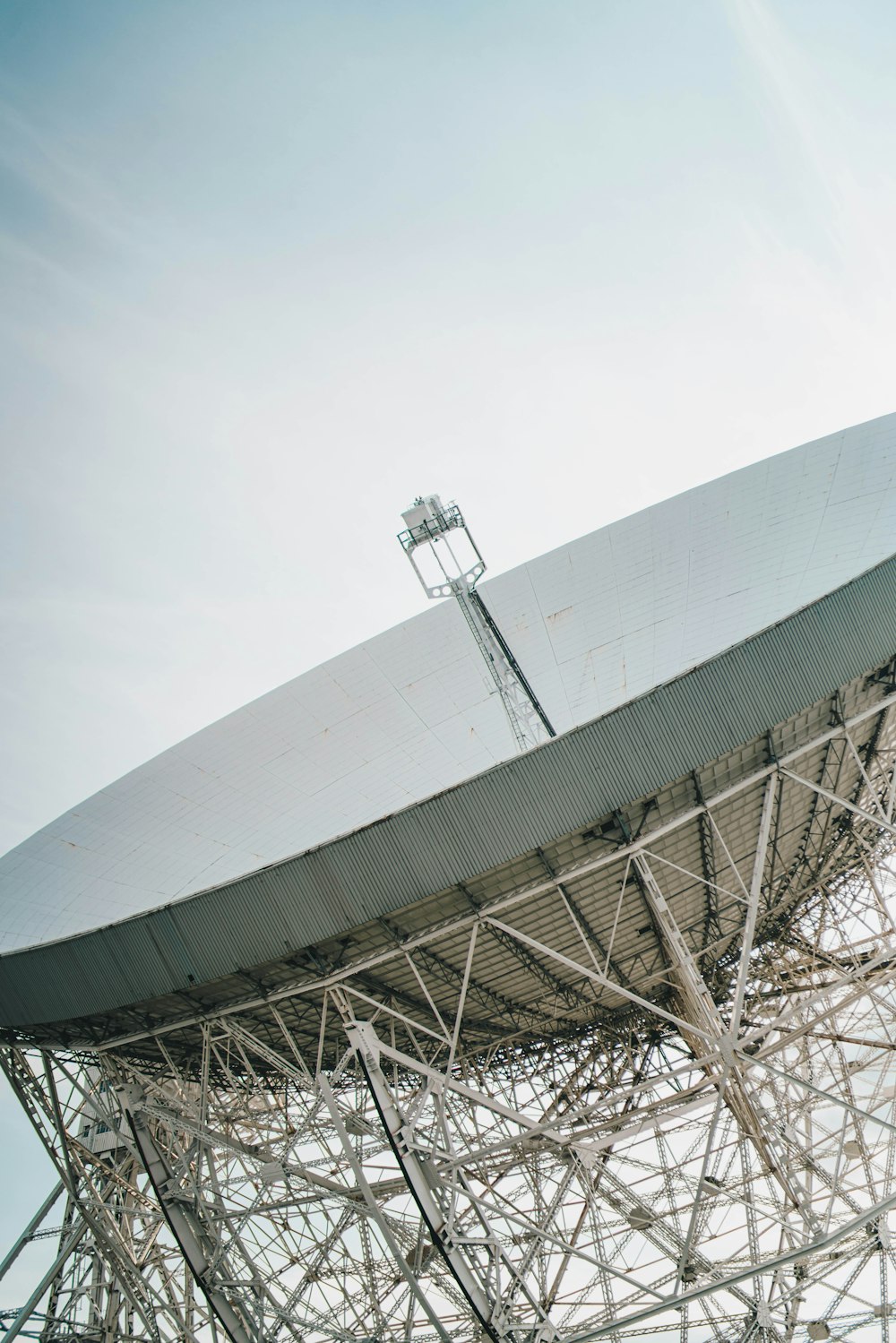 a large satellite dish sitting on top of a metal structure