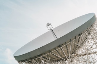 a large satellite dish sitting on top of a metal structure
