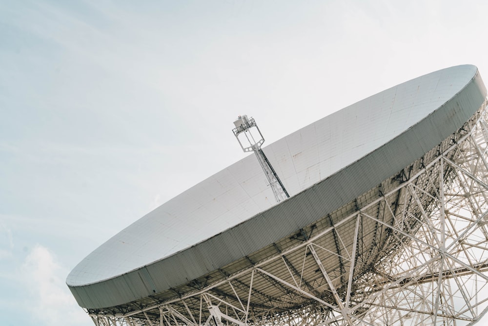 a large satellite dish sitting on top of a metal structure