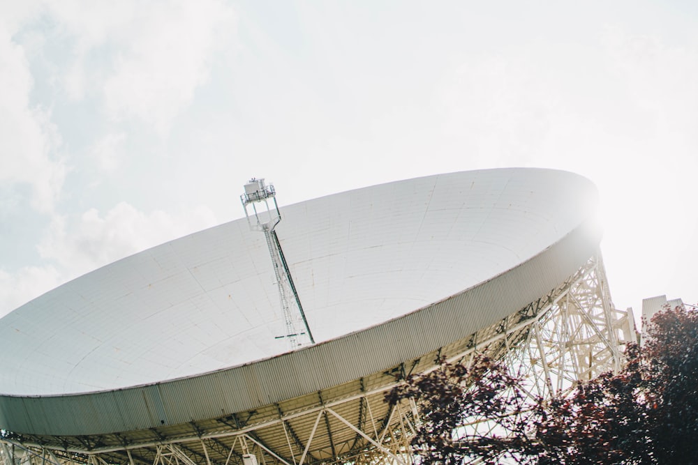 a large satellite dish sitting on top of a metal structure