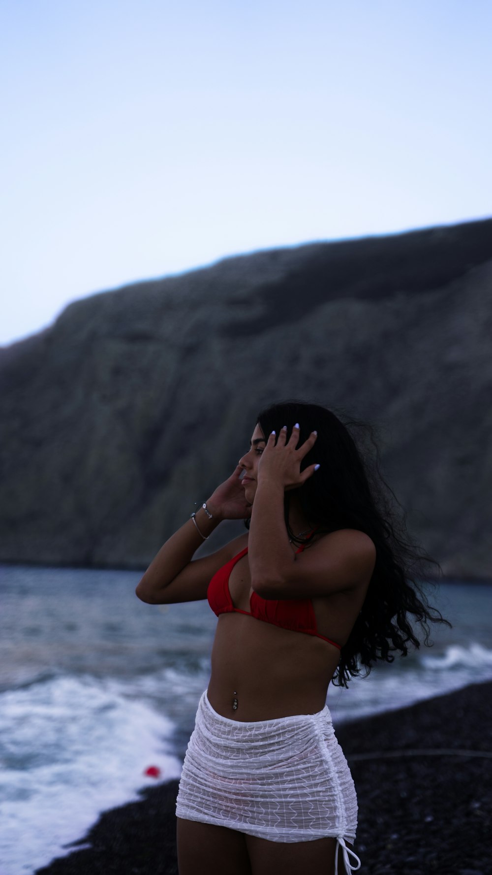 a woman in a bikini standing on a beach