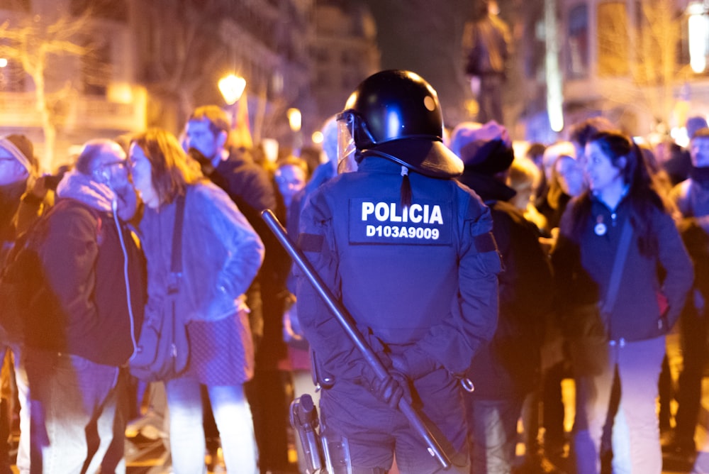 a police officer standing in front of a crowd of people