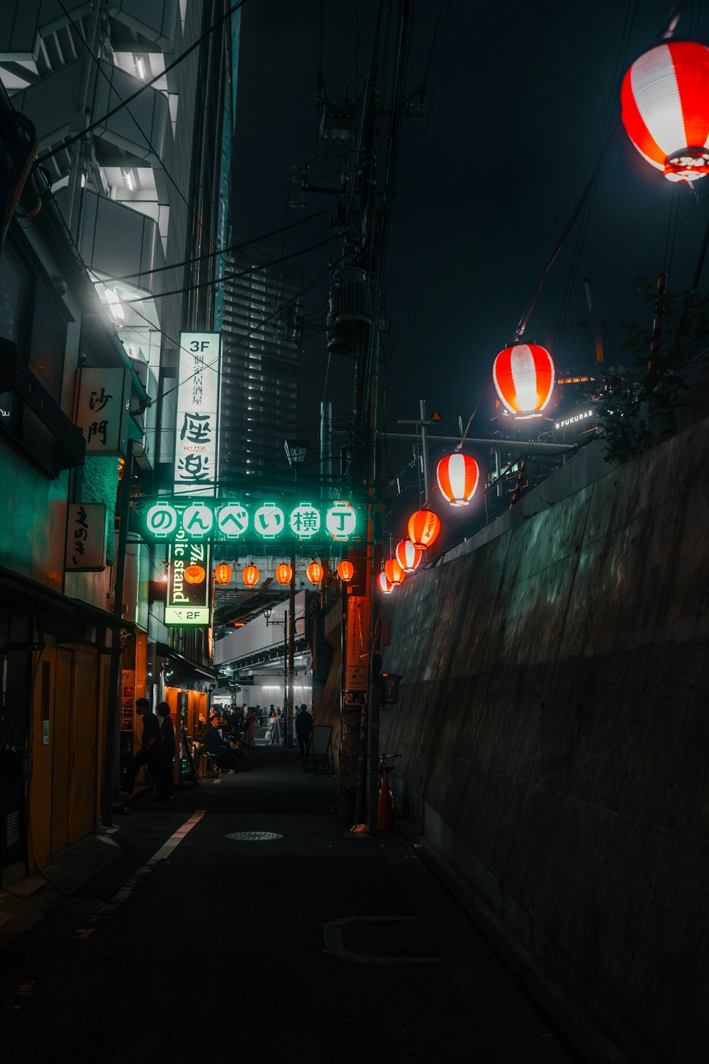 a narrow street with a lot of lights on it