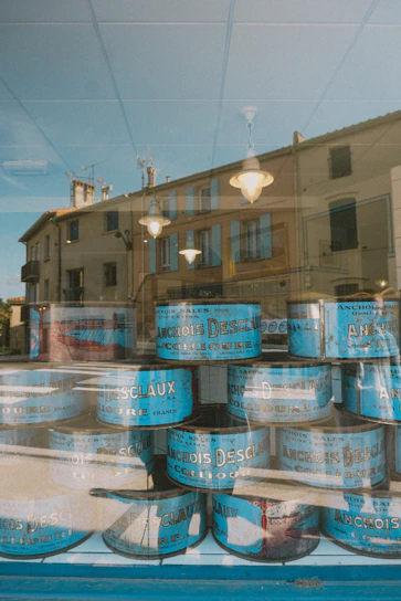 Close-up of artisanal anchovies packed in traditional wooden boxes with sea-inspired colors