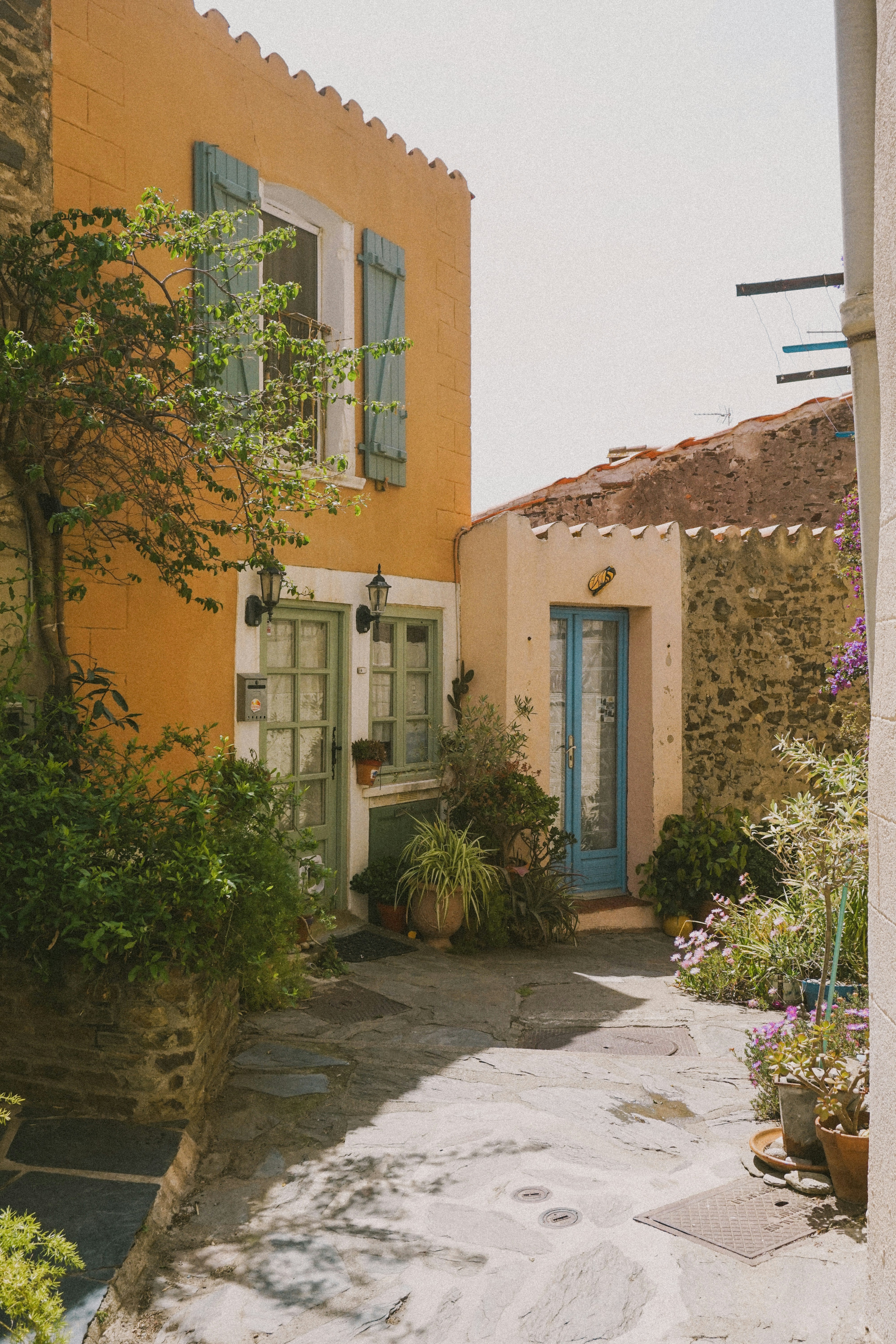 a yellow house with a blue door and window