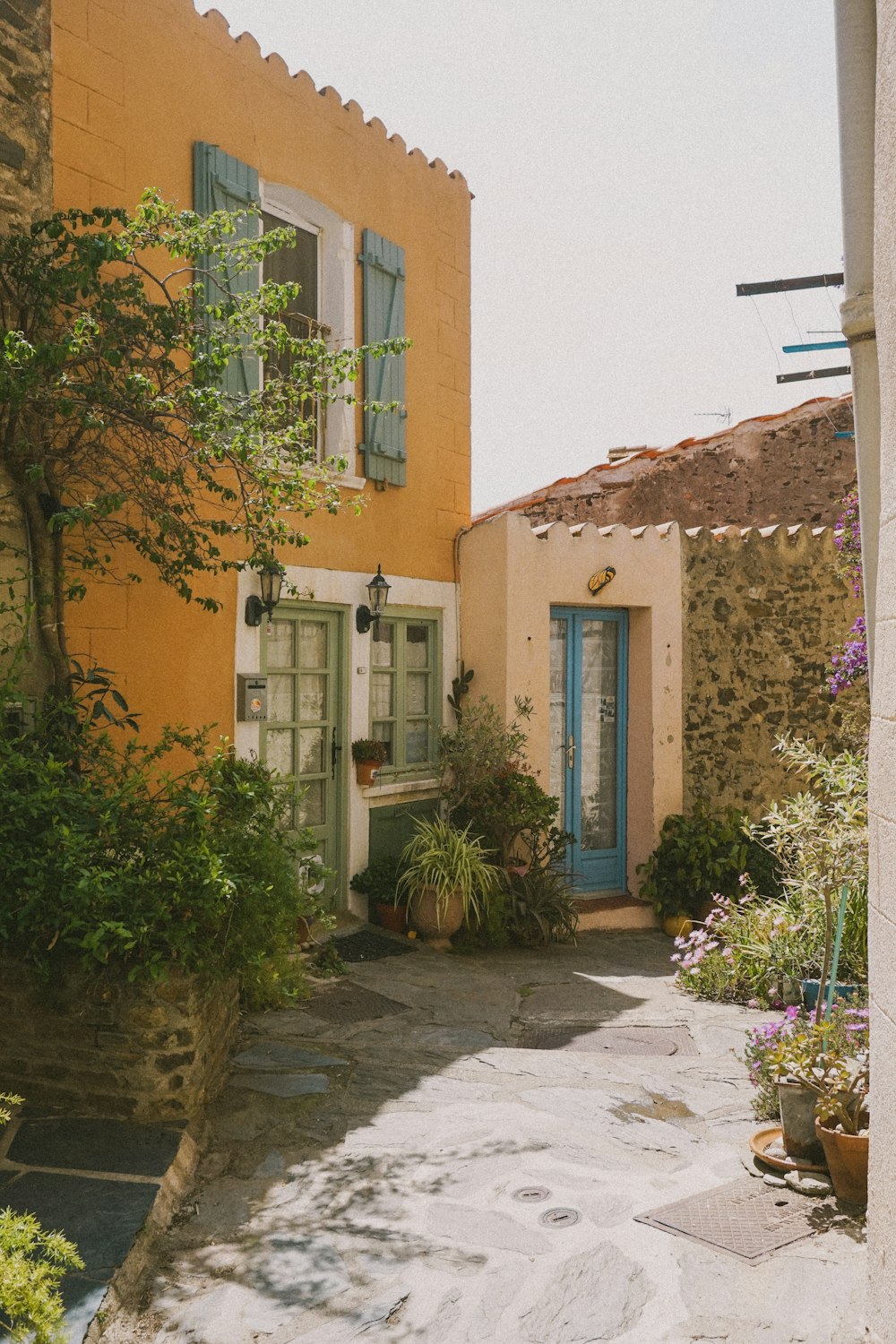 a yellow house with a blue door and window