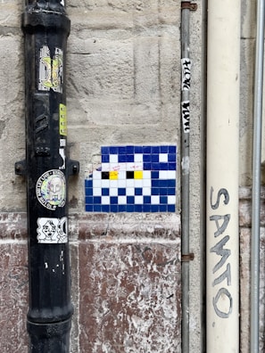 A video frame highlighting the final touches on a colorful mosaic wall.