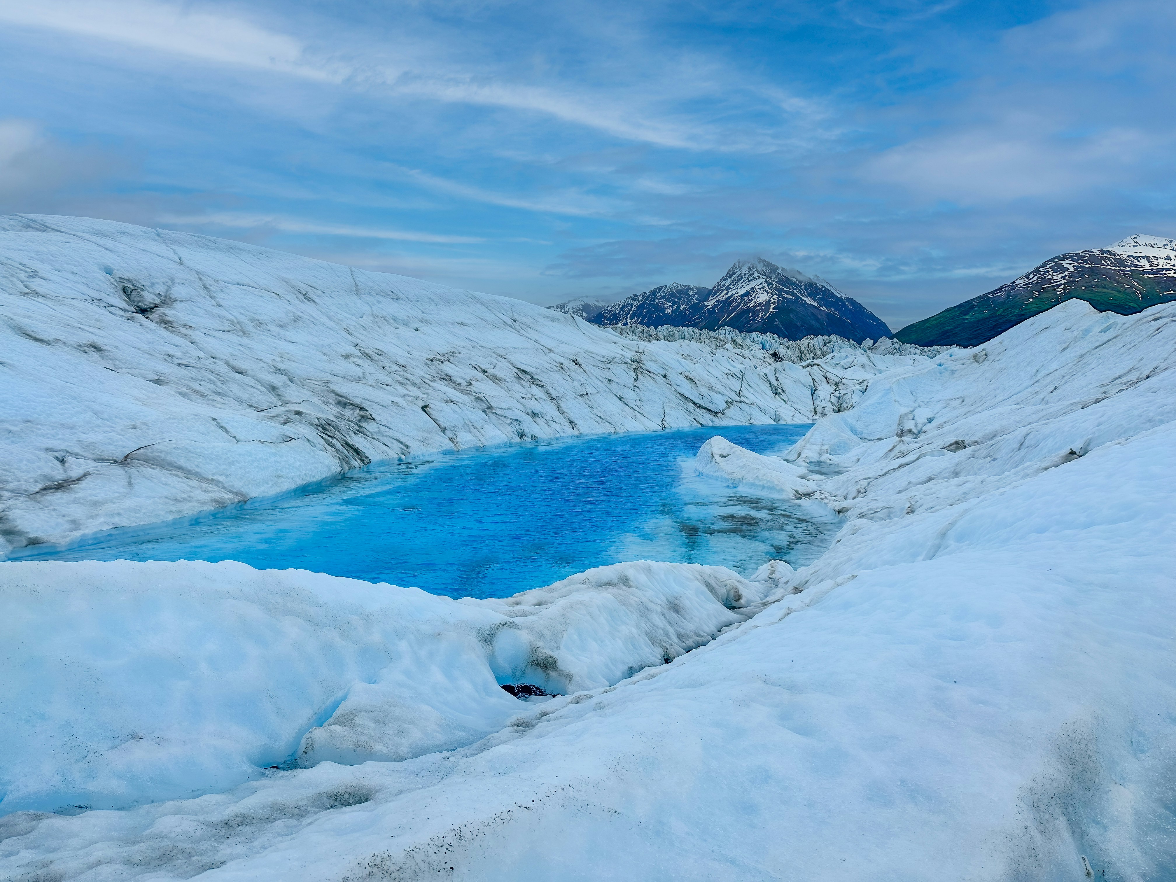 a large body of water surrounded by snow, Knik glacier in Alaska