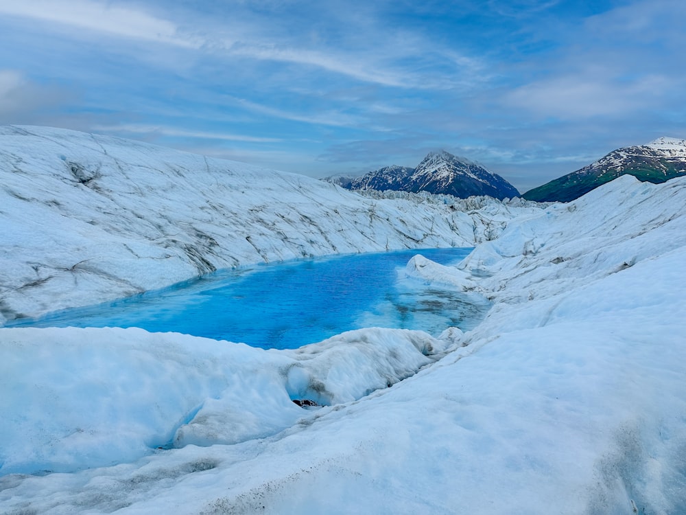 a large body of water surrounded by snow