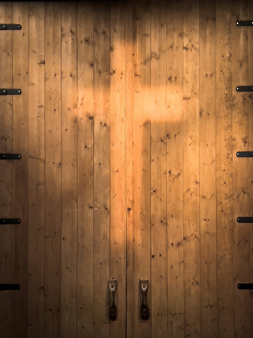 a wooden door with a cross on it
