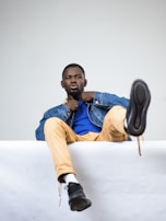 A casual outfit comprising a comfortable denim jacket paired with a simple t-shirt and trousers.