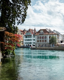a river running through a city next to tall buildings