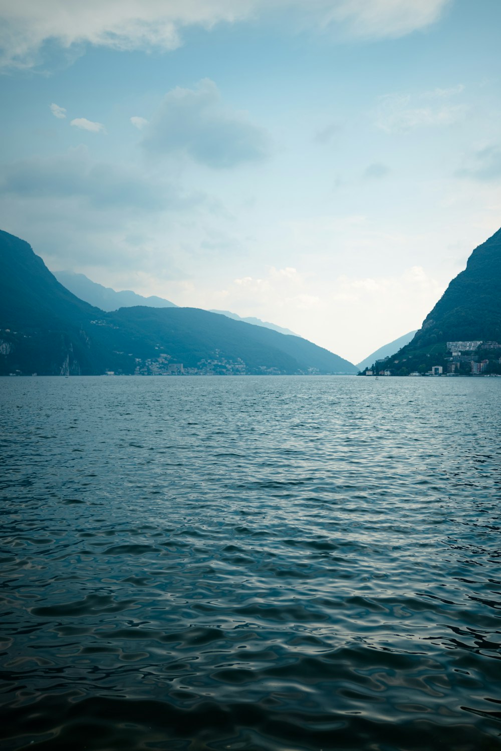 a body of water with mountains in the background