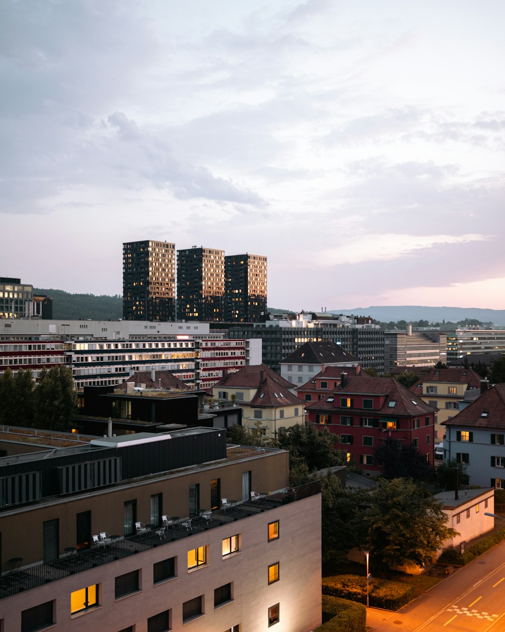 a view of a city at dusk with buildings lit up