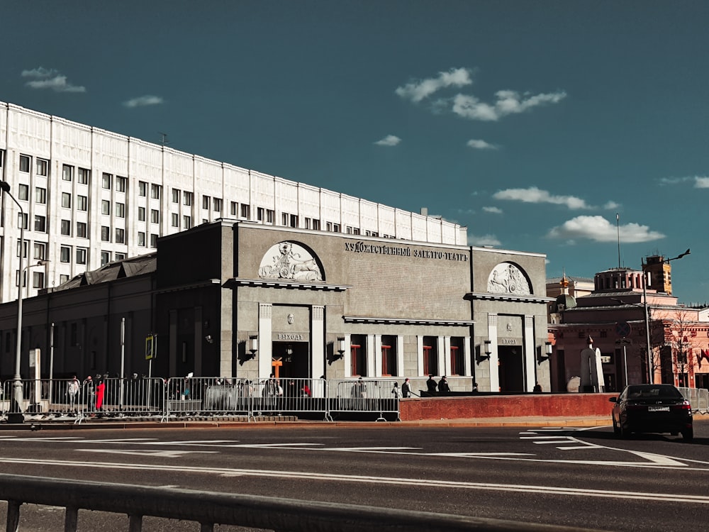 a large building with a tall white building in the background