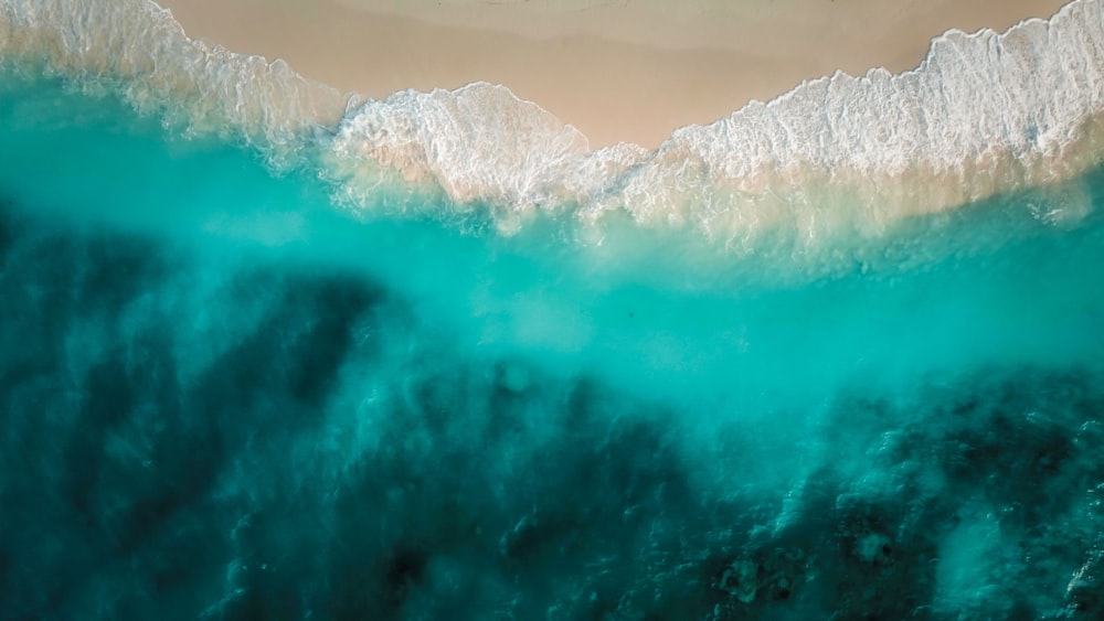 an aerial view of the ocean with waves