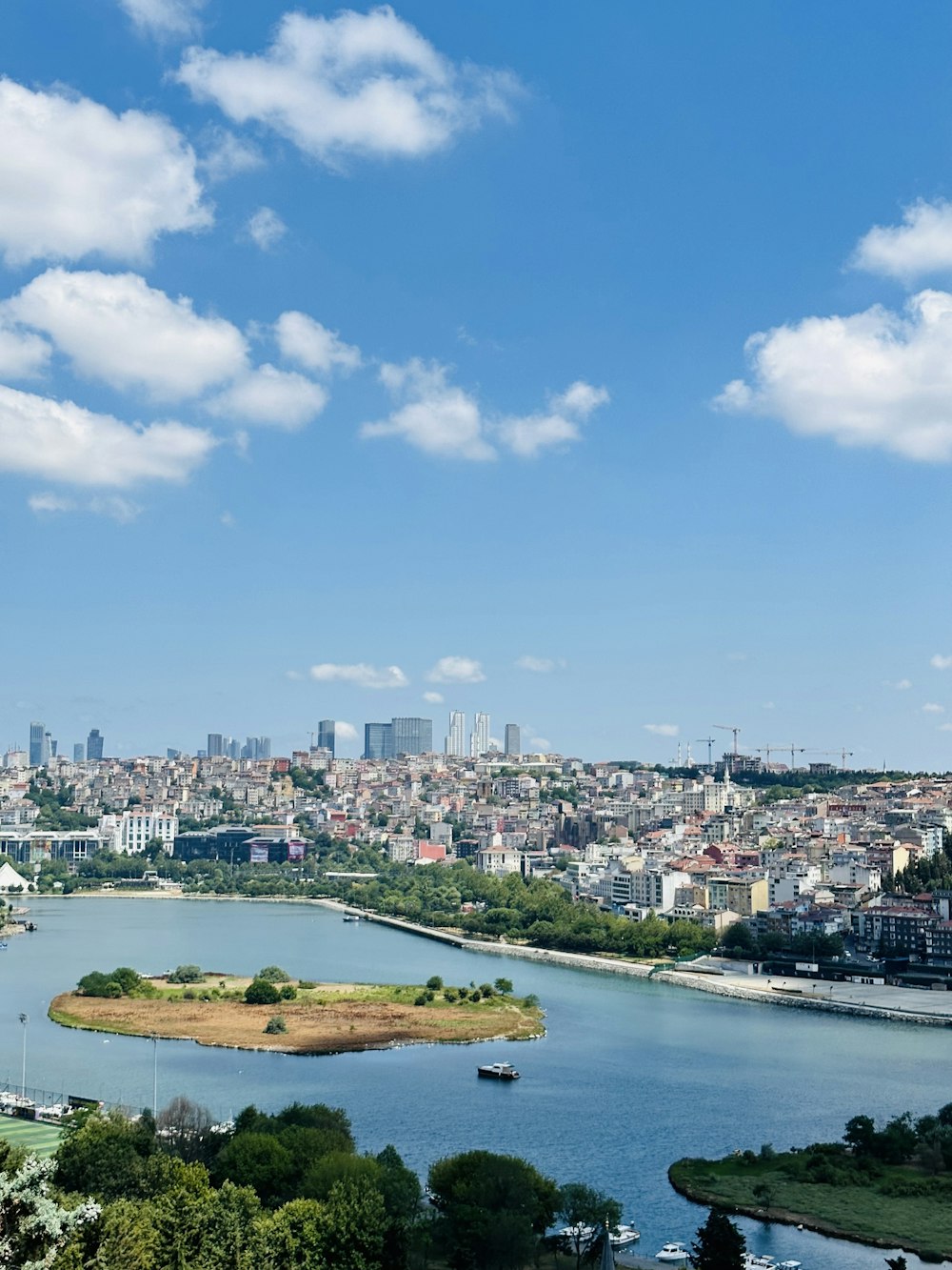 a river running through a city next to a large body of water