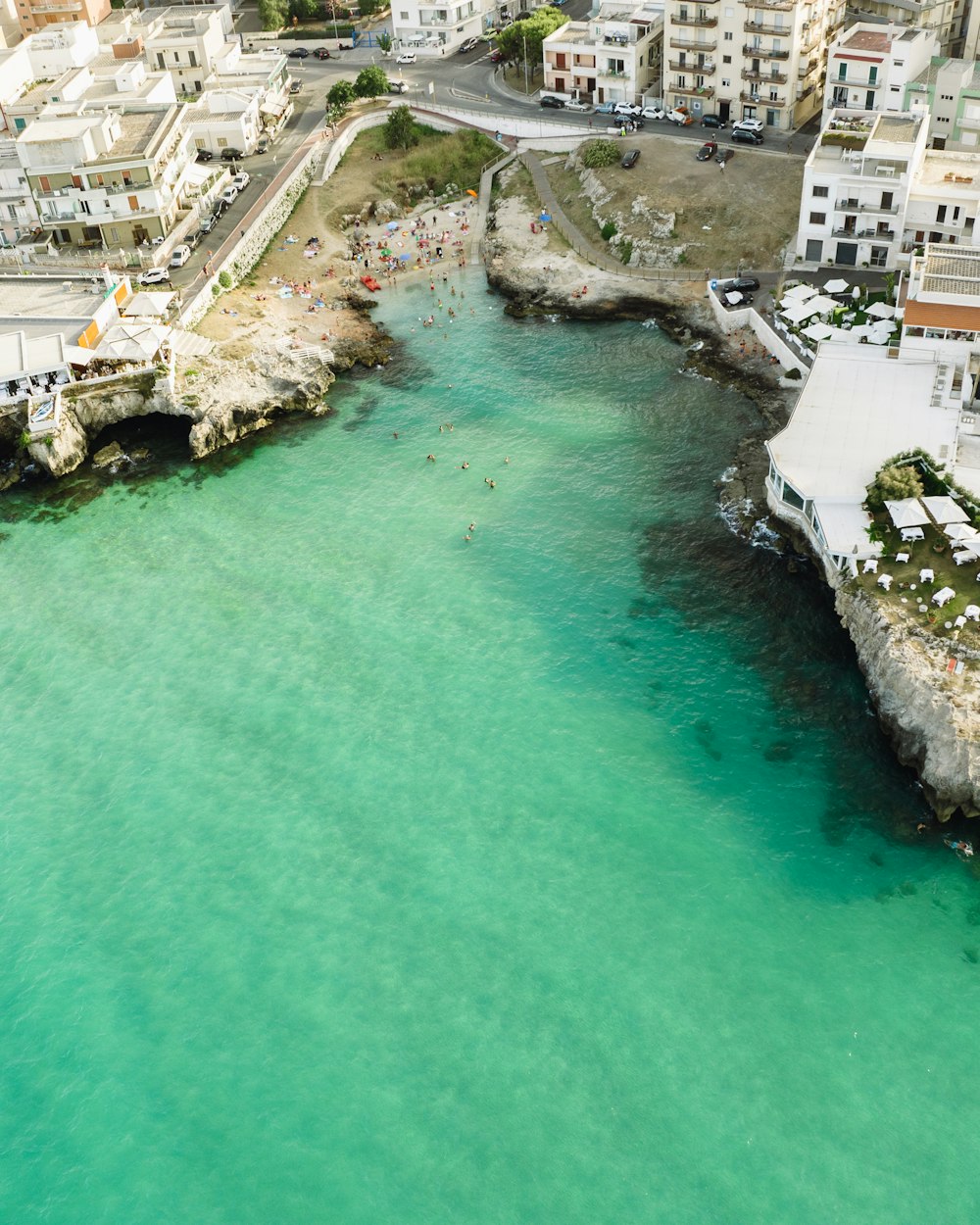 an aerial view of a body of water with buildings in the background