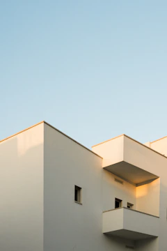 A sleek modern villa with sharp architectural lines and pristine white facade.
