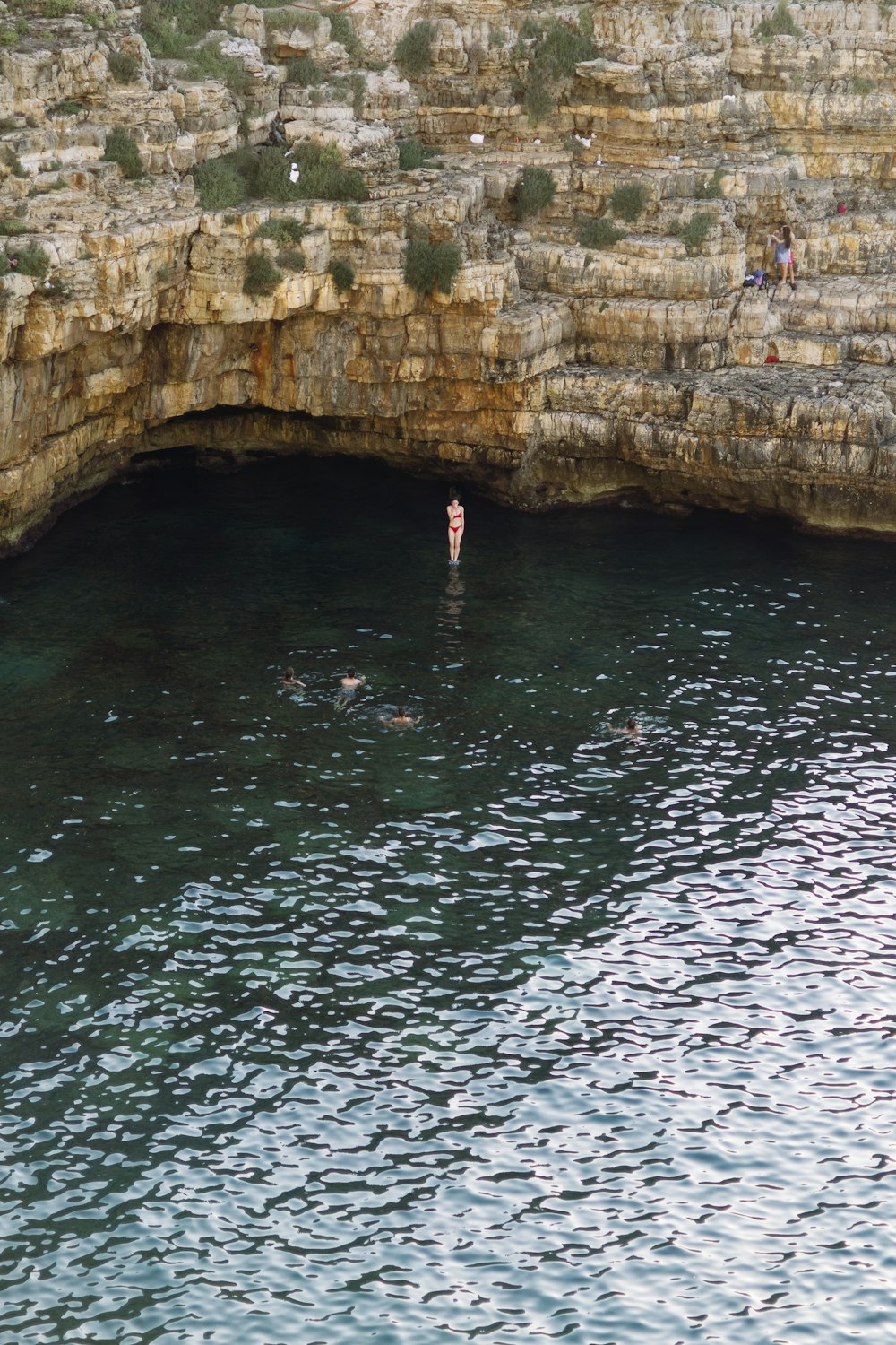 a body of water with people swimming in it