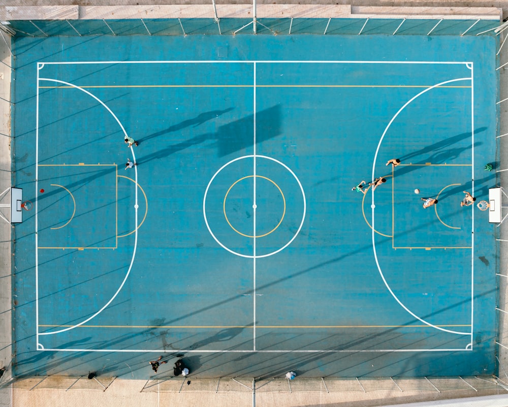 an overhead view of a basketball court with people playing