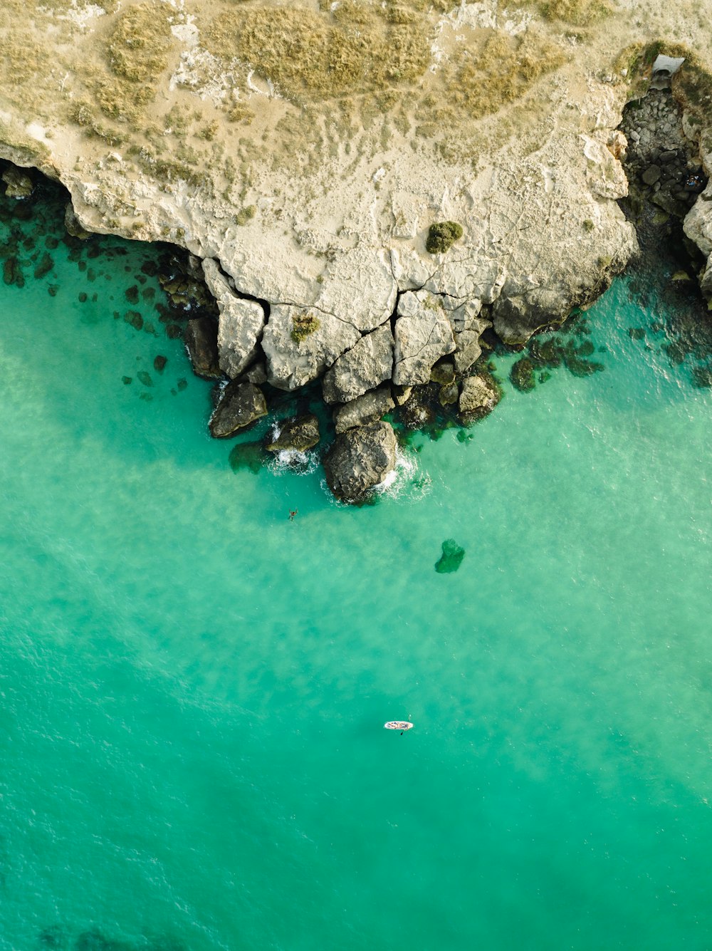 an aerial view of a beach with a body of water