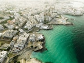 Aerial view of Alicante city with coastline and buildings.