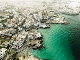 Aerial view of Alicante city with coastline and buildings.