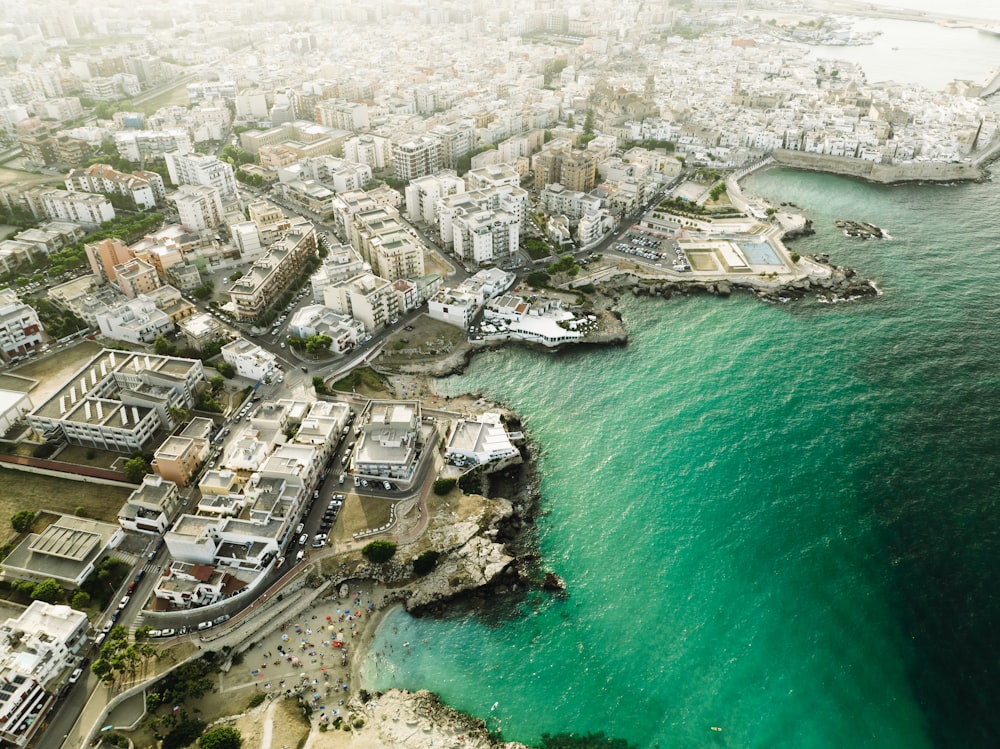 an aerial view of a city next to the ocean