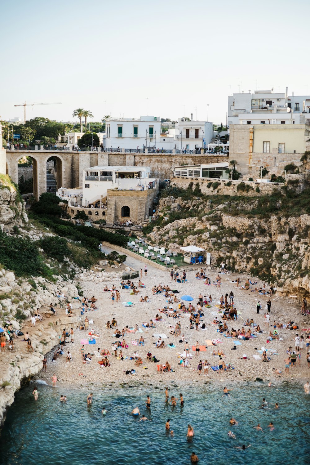 a group of people on a beach next to a body of water