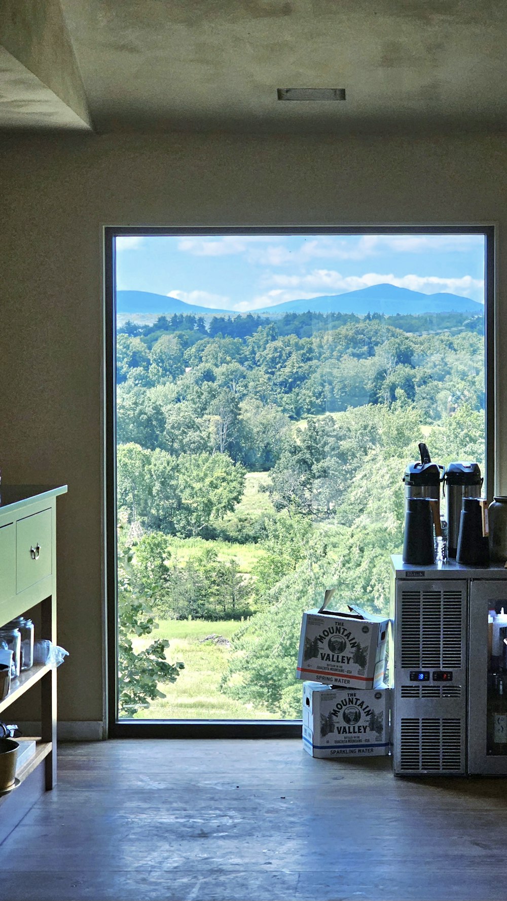 a kitchen with a view of the mountains outside the window