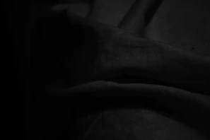 Abstract composition of fabric folds creating dynamic shadows and light