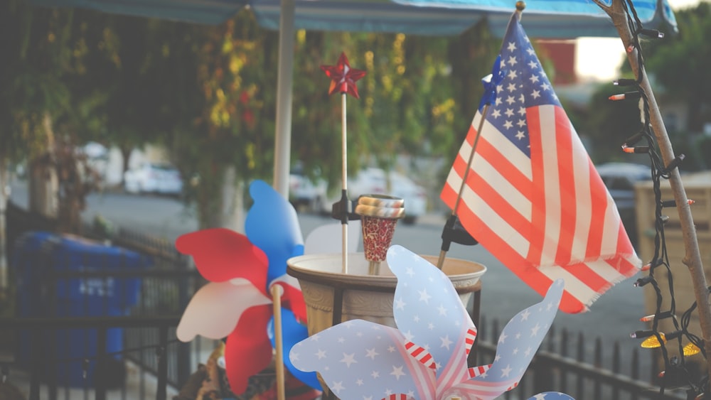 a bunch of american flags and pinwheels on a table