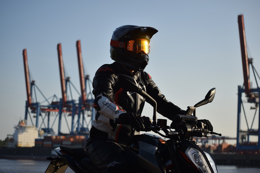 a person wearing a helmet sitting on a motorcycle