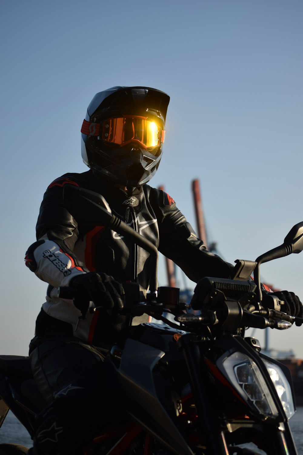 a person wearing a helmet sitting on a motorcycle