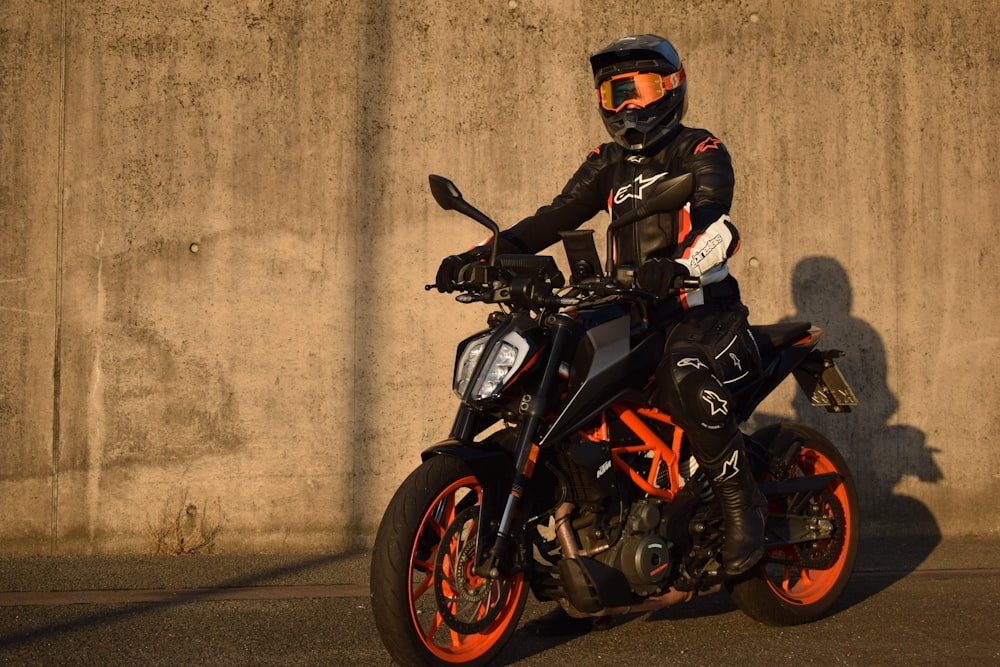 a man in a helmet is sitting on a motorcycle